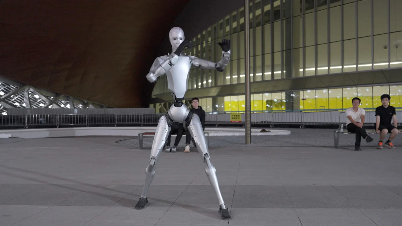 H2 in a dynamic motion-control stance outdoors at night.