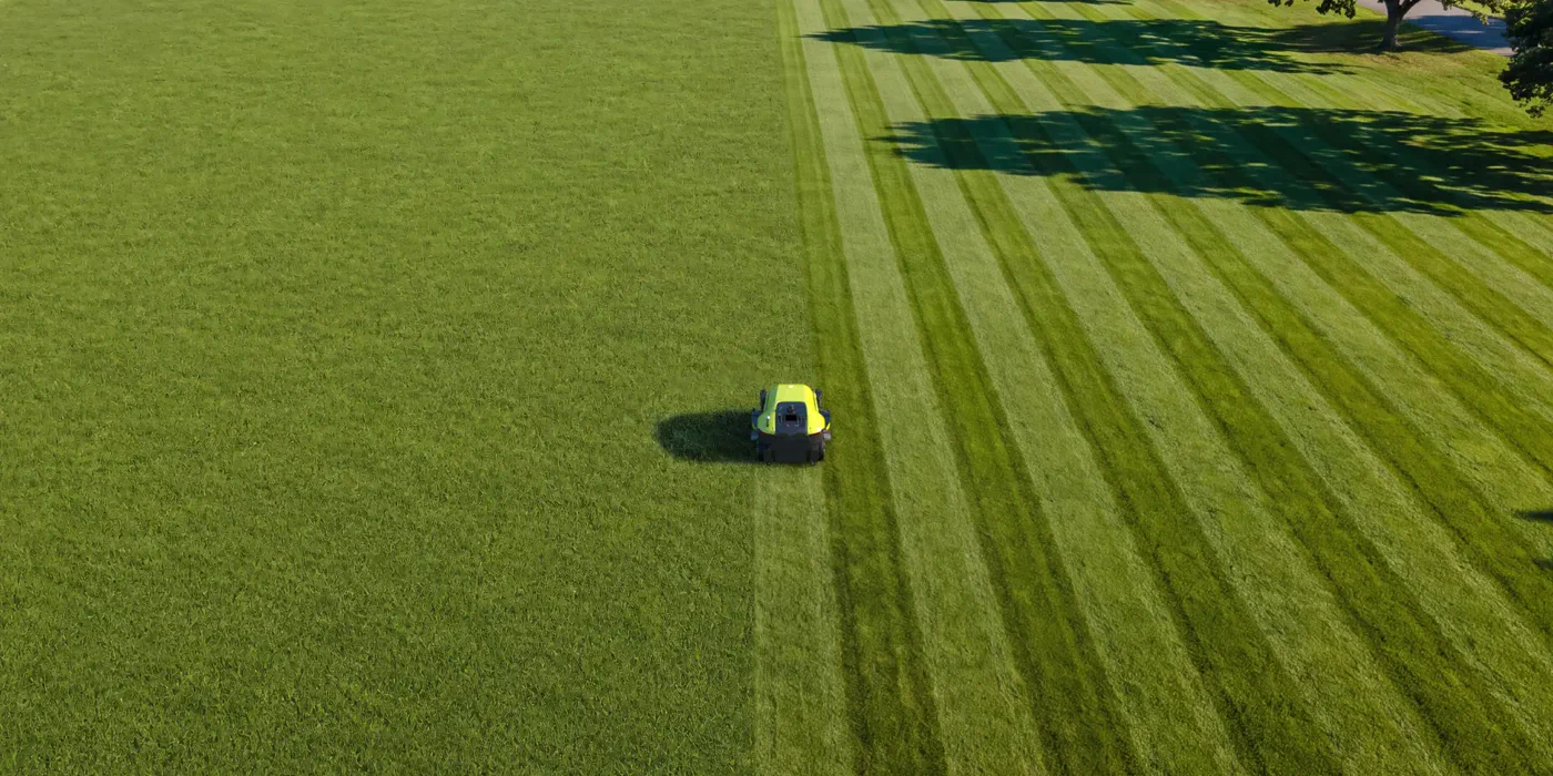 Large-area mowing with broad parallel passes.