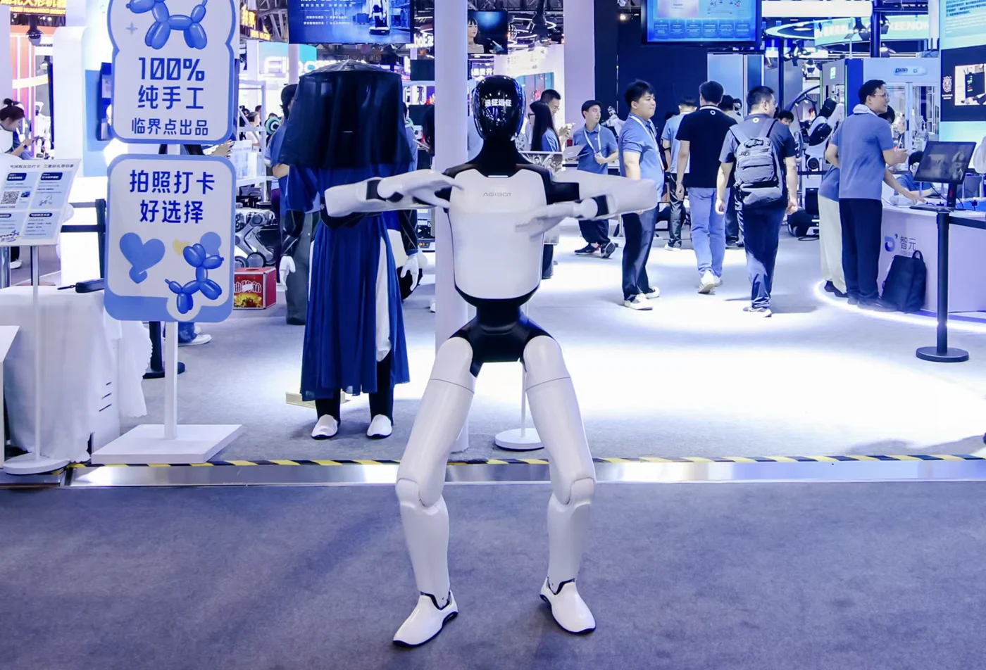 Full-body humanoid at an exhibition, arms extended.
