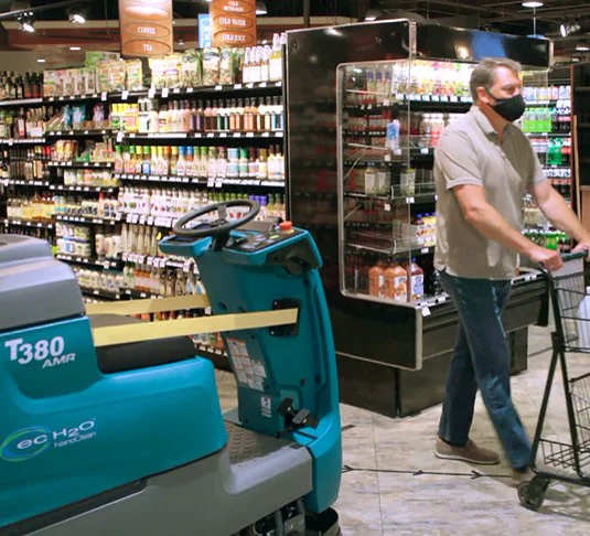 Cleaning alongside shoppers in a grocery store