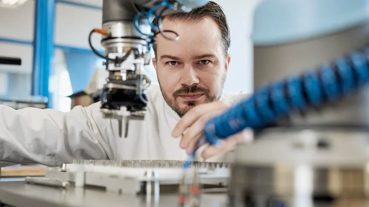 Collaborative robotic arm tending an industrial machine